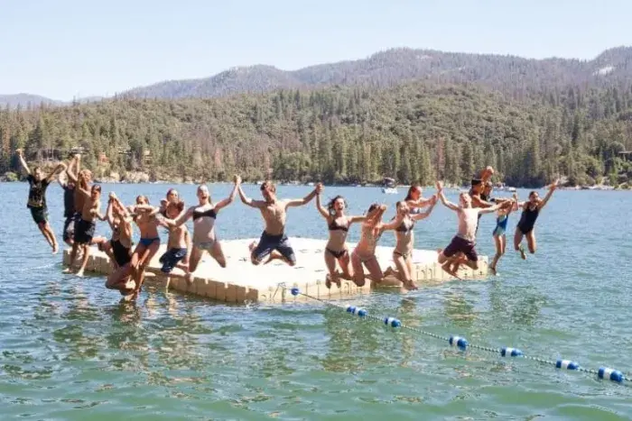 Campers jumping into Bass Lake