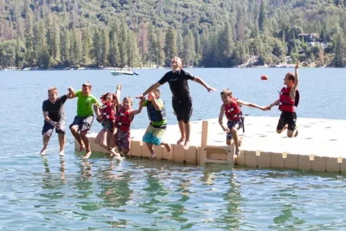 Campers jumping off dock