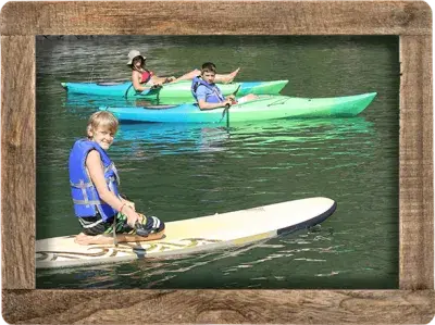 Campers on paddleboards and kayaks