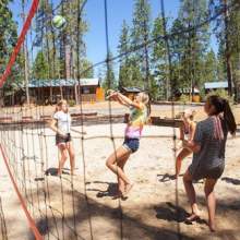 Girls playing sand volleyball